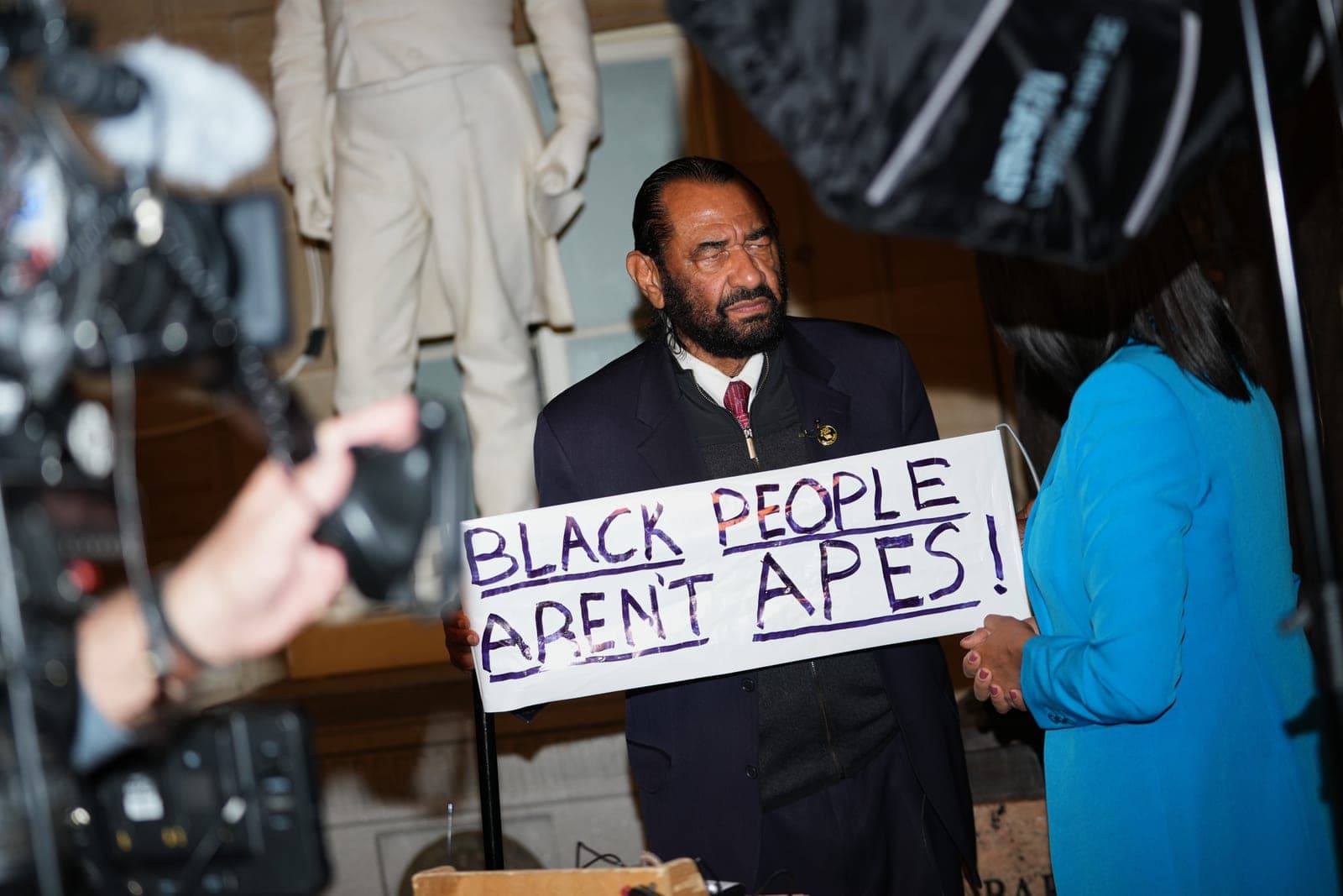 Democratic Rep. Al Green holds 'Black People Aren't Apes' sign as he is booted from Trump State of the Union