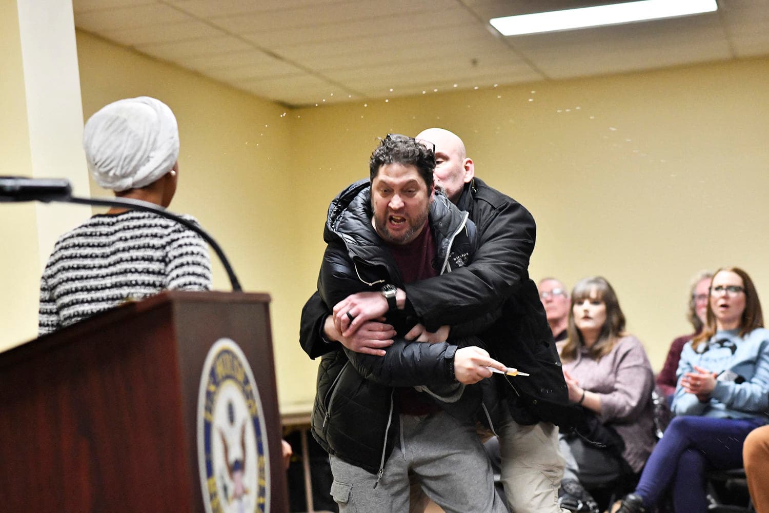 Man lunges at Rep. Ilhan Omar during town hall and tries to spray her with unknown substance